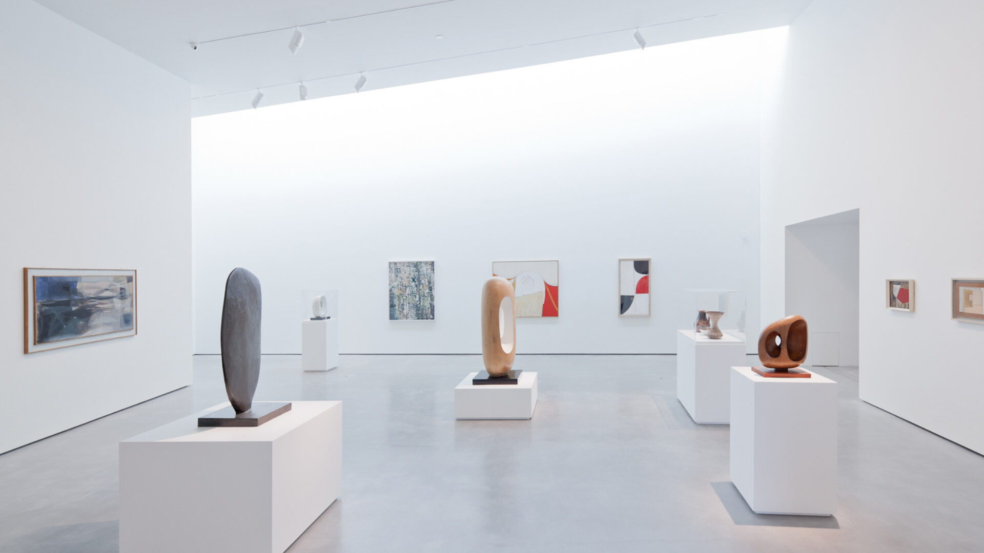 A display of sculptures in a gallery of the Hepworth Wakefield with white walls and natural light from above
