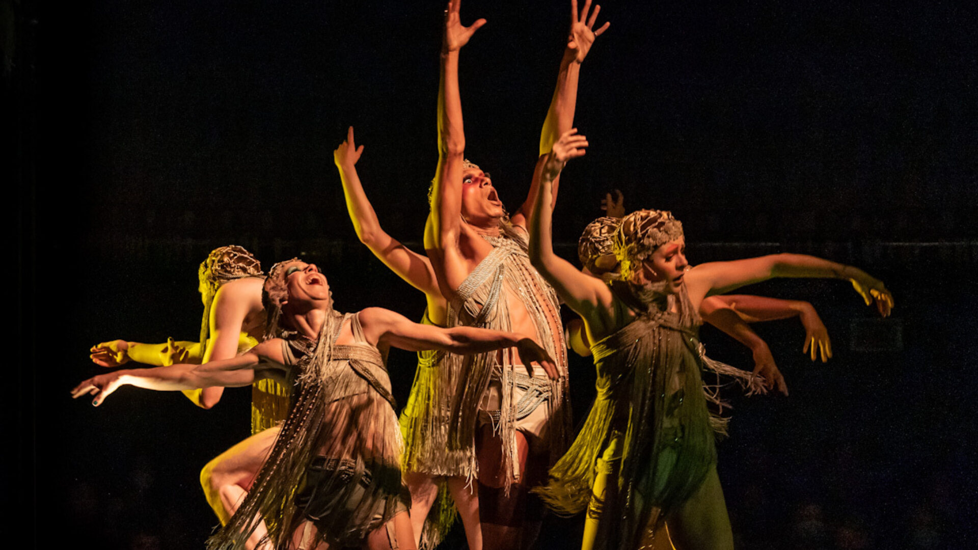 Playhouse Theatre production photo of the ensemble of Cabaret dancing, with green lighting.